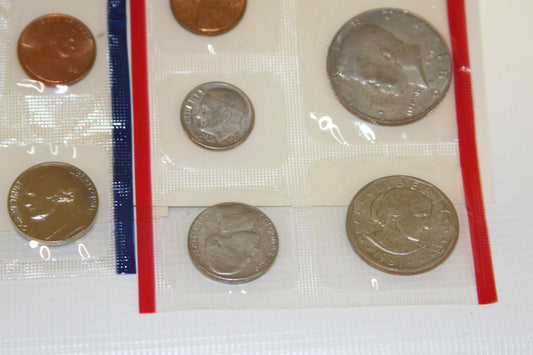 Close-up of uncirculated 1981 mint coins in plastic sleeves