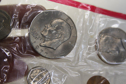 Close-up of Eisenhower dollar and other 1977 coins in original packaging