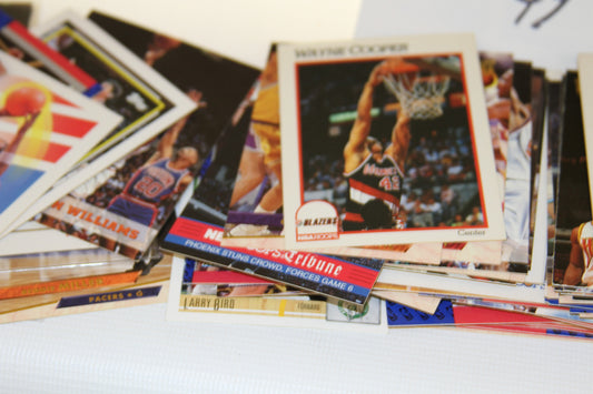 Close-up of vintage NBA cards featuring Wayne Cooper and Larry Bird
