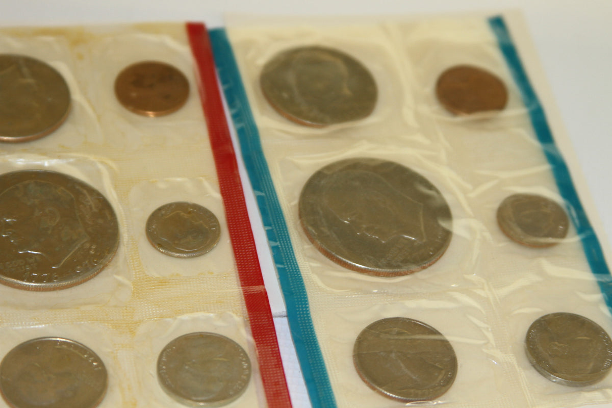Close-up of 1975 coin set showing sealed uncirculated coins with red and blue borders