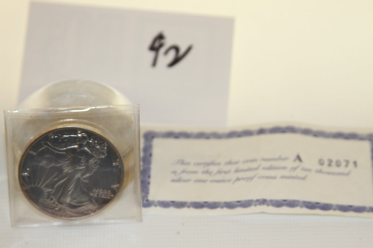 1989 Silver American Eagle proof coin with certificate and handwritten note in background