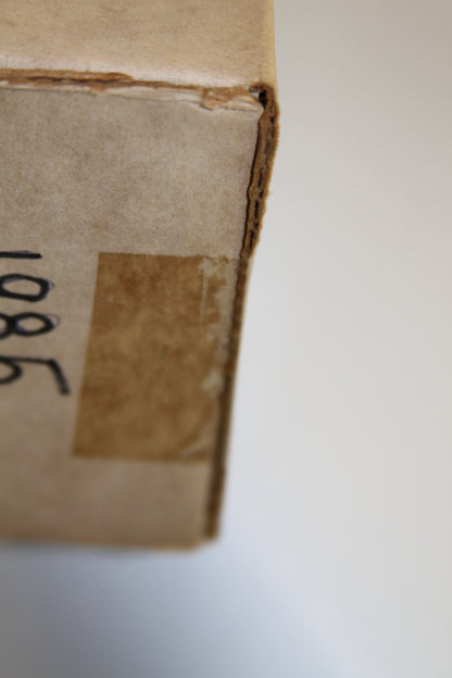 Detail of box's corner with handwritten label and tape