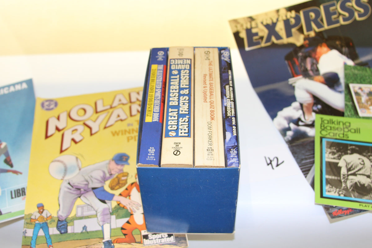 Stack of baseball trivia and record books in a box