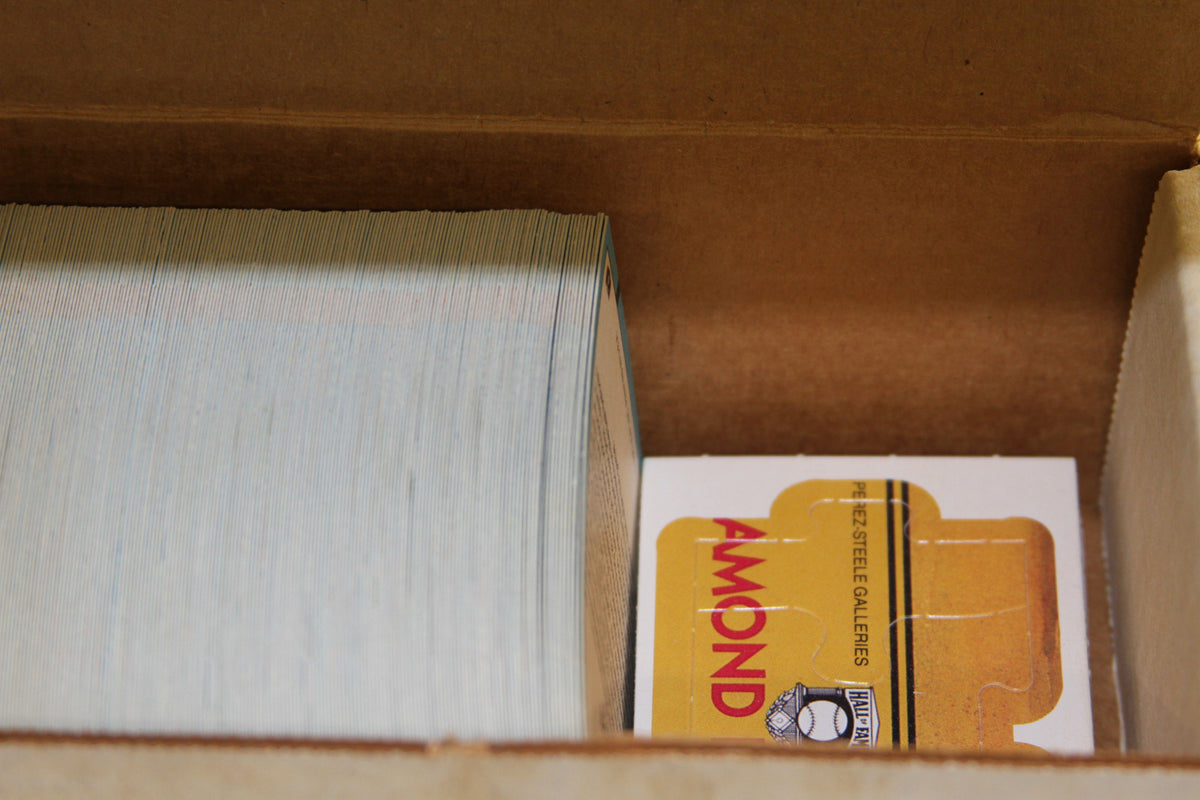 Close-up of baseball cards and a yellow insert in the box