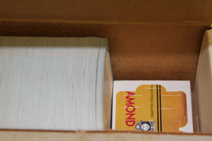 Close-up of baseball cards and a yellow insert in the box