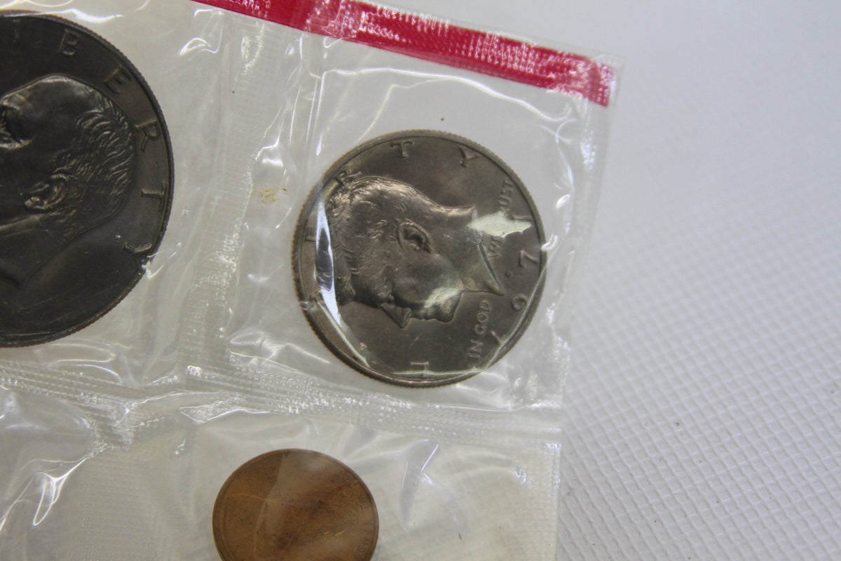 1977 Eisenhower dollar and Kennedy half dollar in sealed coin package