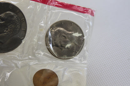 1977 Eisenhower dollar and Kennedy half dollar in sealed coin package
