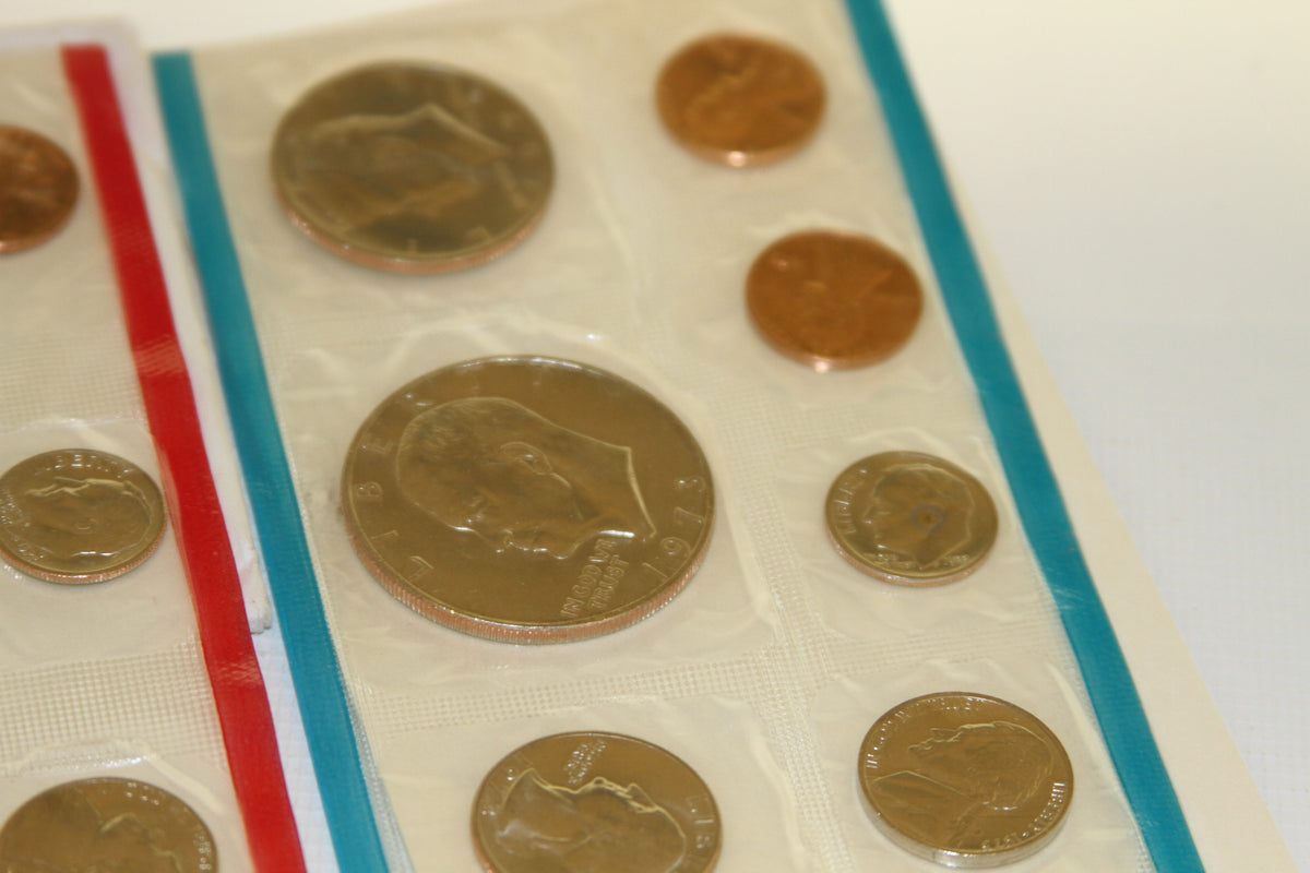 Detailed view of uncirculated coins in blue-edged mint packaging from 1973 set