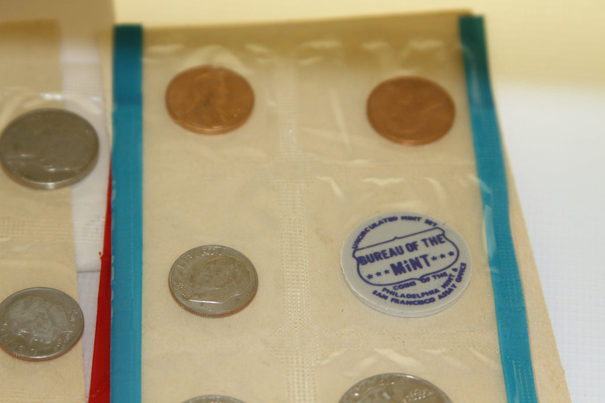 Coins from 1970 US Mint set showing Bureau of the Mint medallion in blue