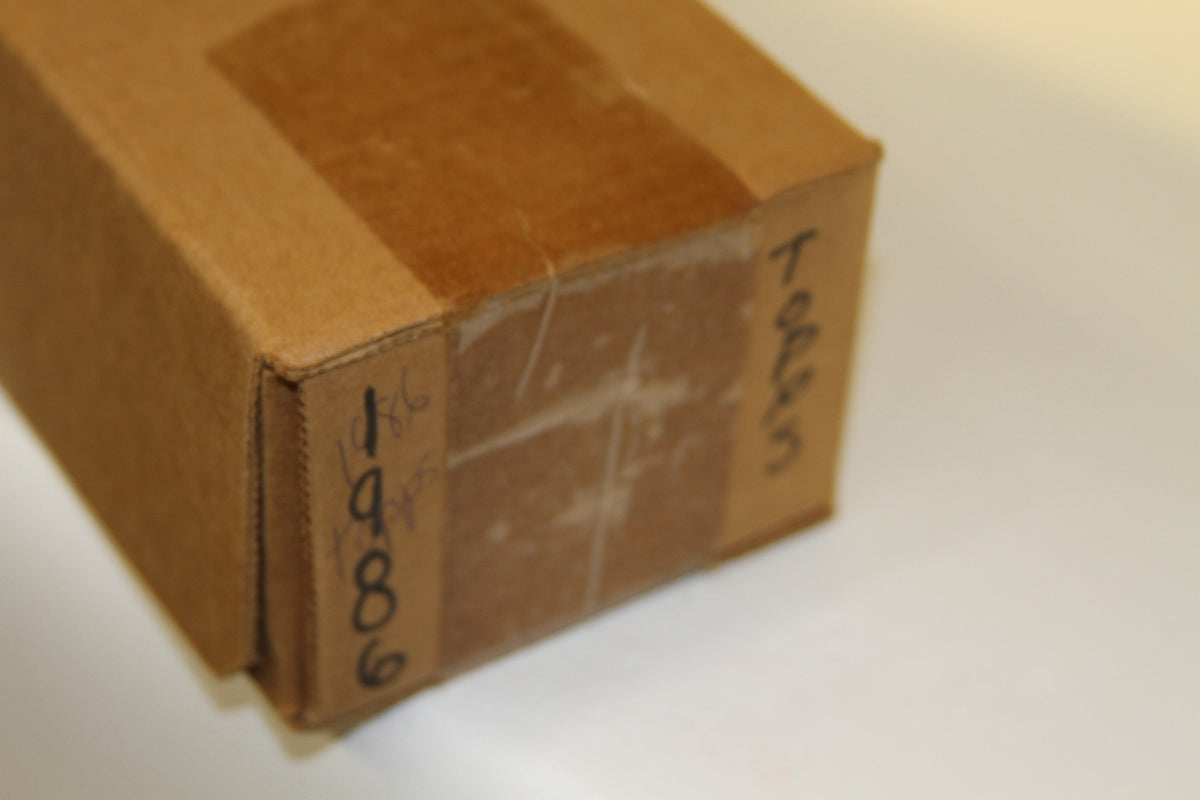 Corner detail showing handwritten 'Topps' and '1986' on brown box