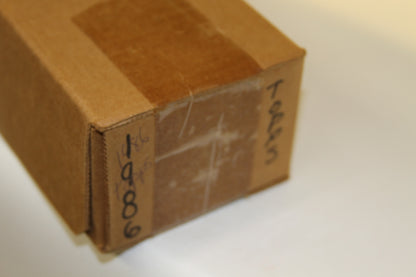 Corner detail showing handwritten 'Topps' and '1986' on brown box