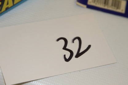 Handwritten number 32 on white card next to Topps box