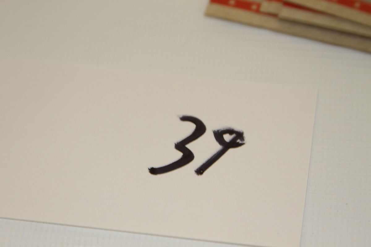 White card with handwritten number 39
