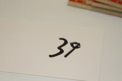 White card with handwritten number 39