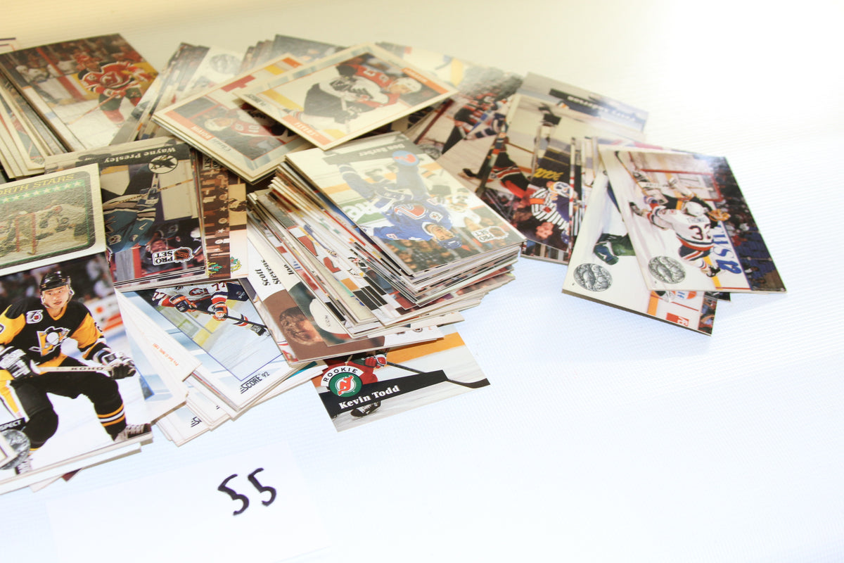 Angled shot focusing on NHL hockey trading cards, including a visible 'Kevin Todd' rookie card.