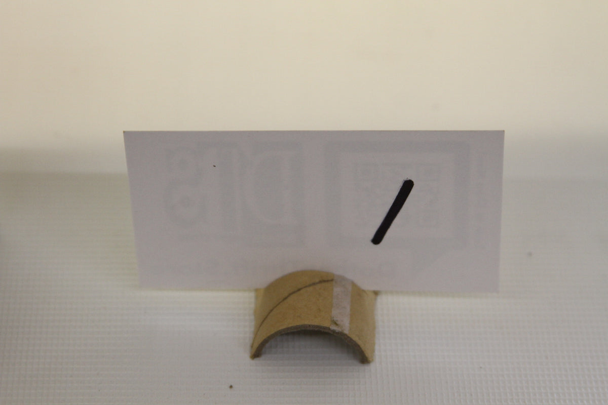 Card holder with blank white card and black slash mark