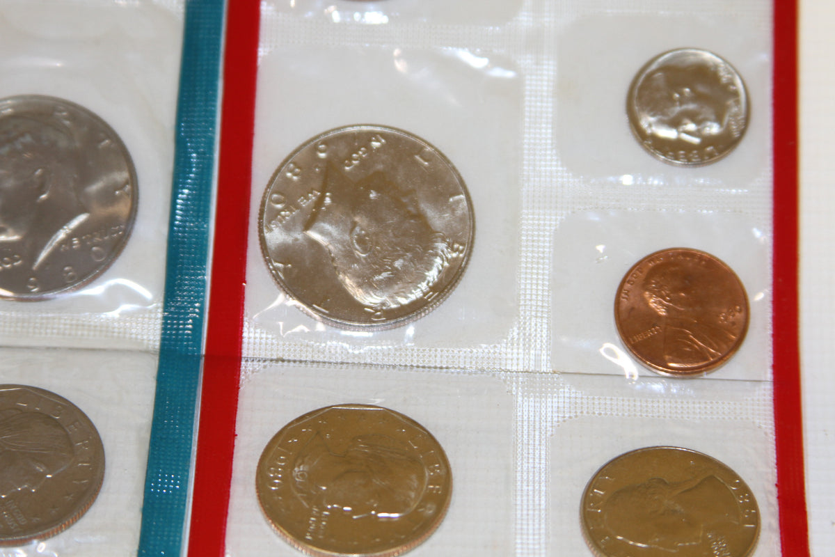 Detail of Eisenhower dollar and Lincoln cent in uncirculated Mint packaging
