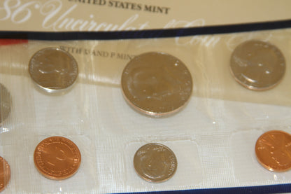 Coins in plastic sleeve from 1986 US Mint set with packaging in background