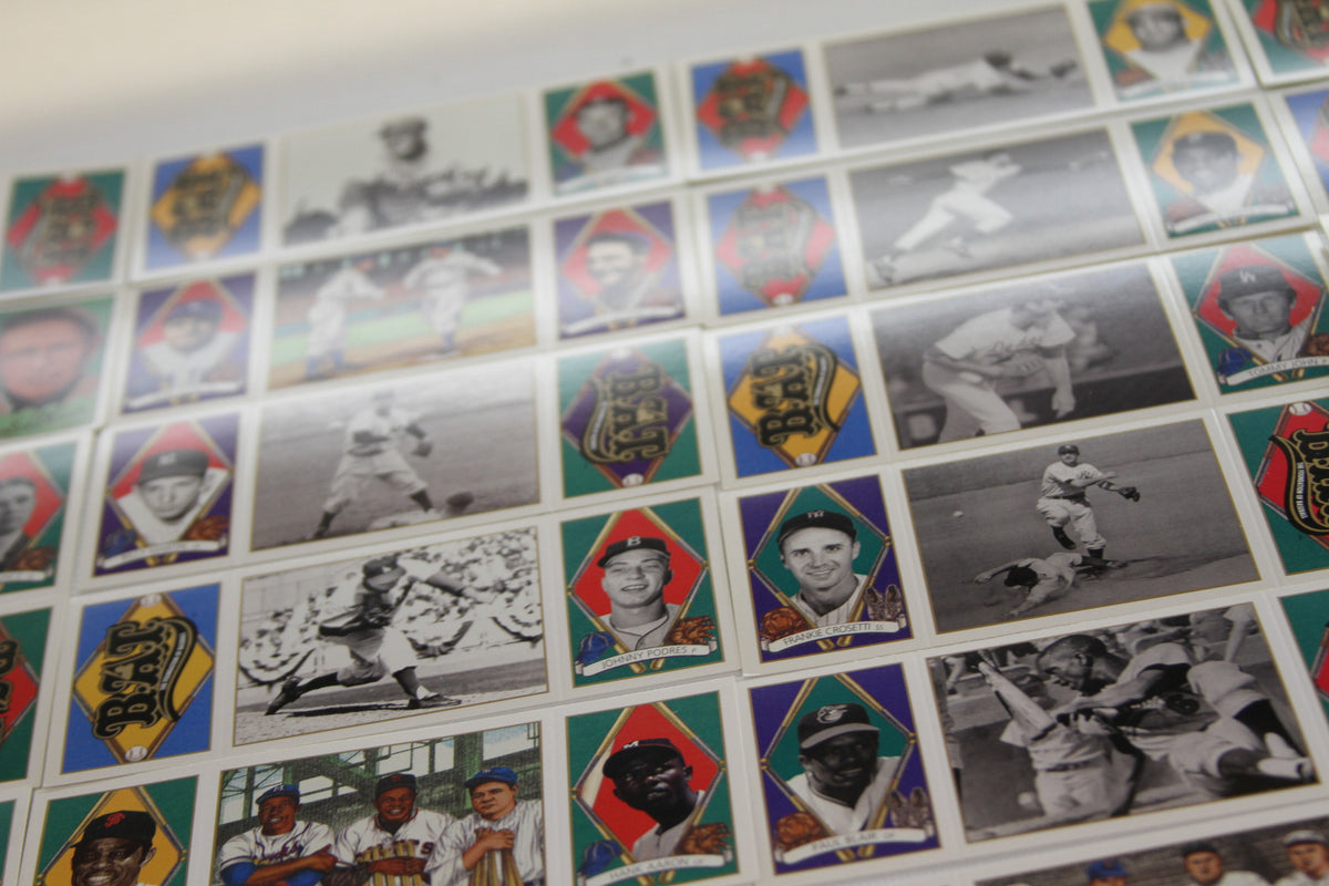 Rows of historical baseball cards and player portraits on uncut sheet