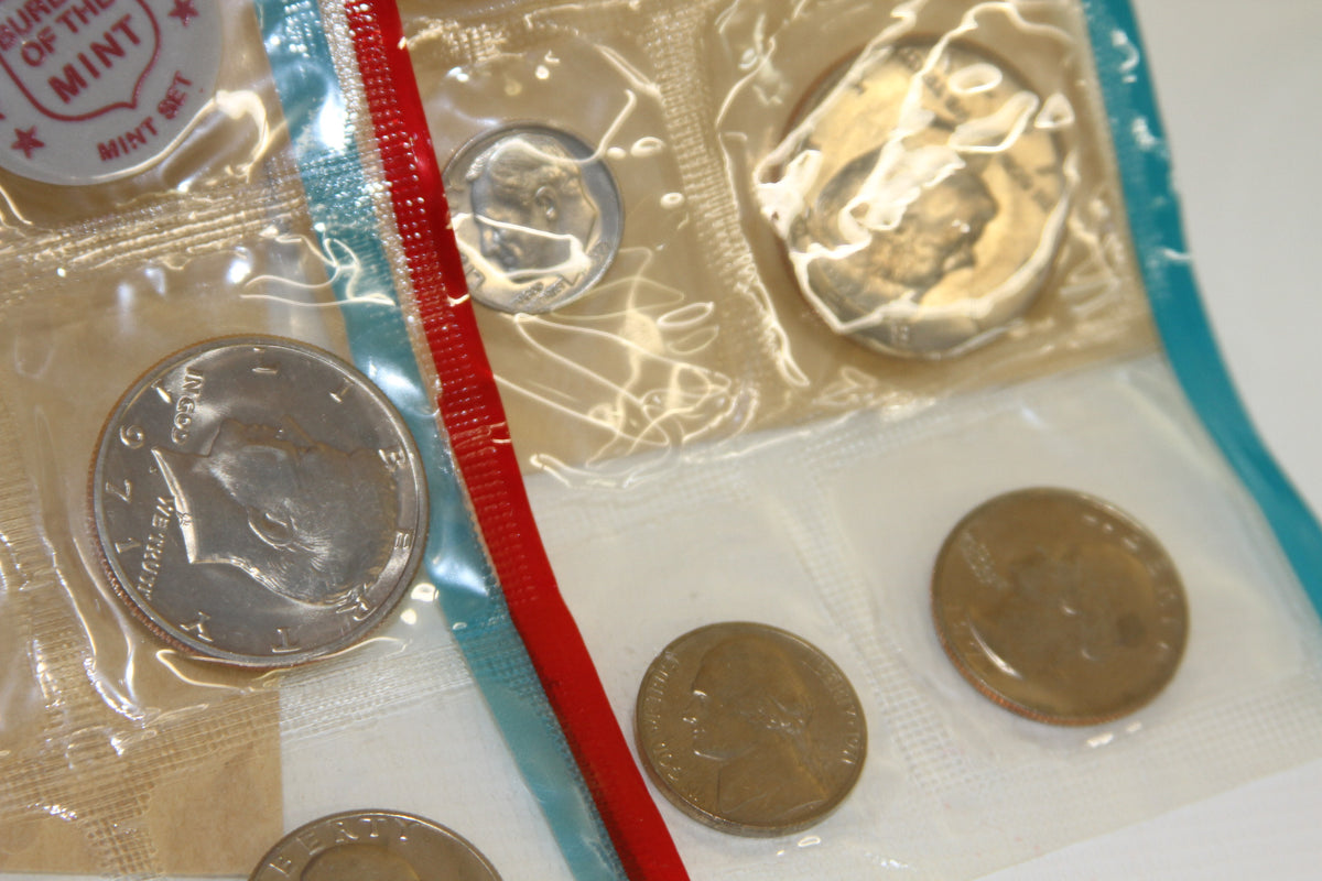 Detail of Kennedy half dollar and other coins in sealed mint packaging