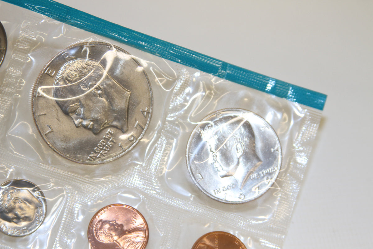 Detail of Kennedy half dollar and coins in blue-edged 1974 Mint packaging