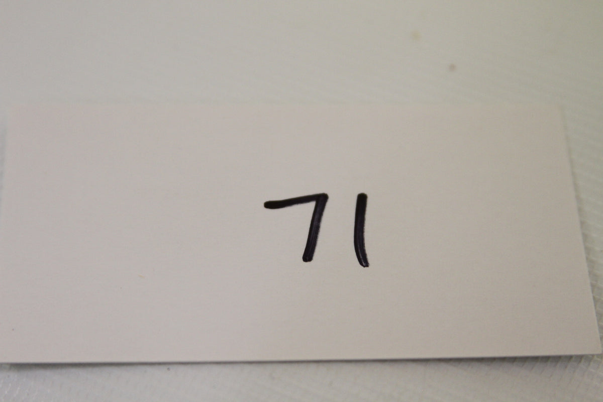 White card with number 71 handwritten