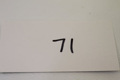 White card with number 71 handwritten