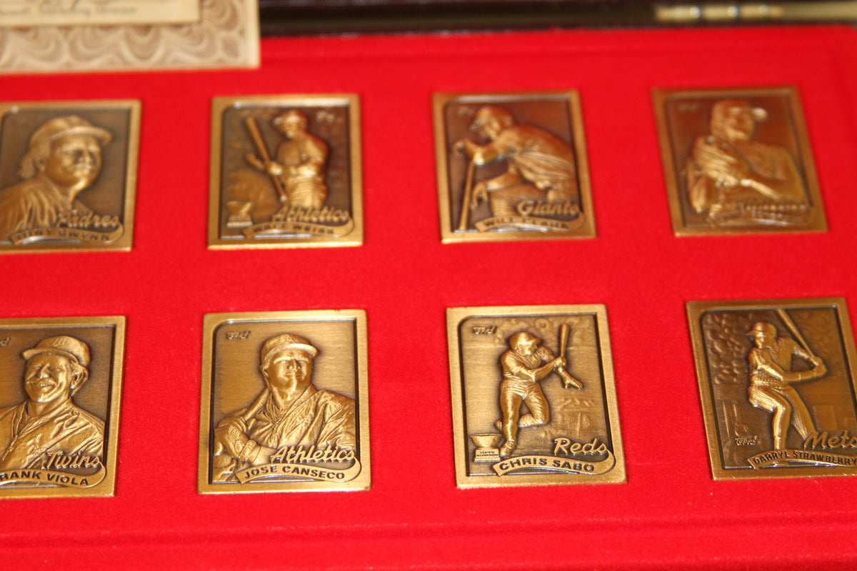 Bronze baseball card replicas from Topps 1989 collection on red felt background