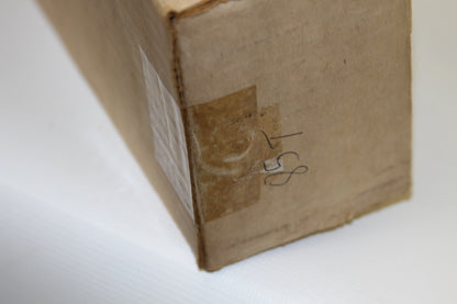 Opposite box corner with handwritten 1985 and taped edge