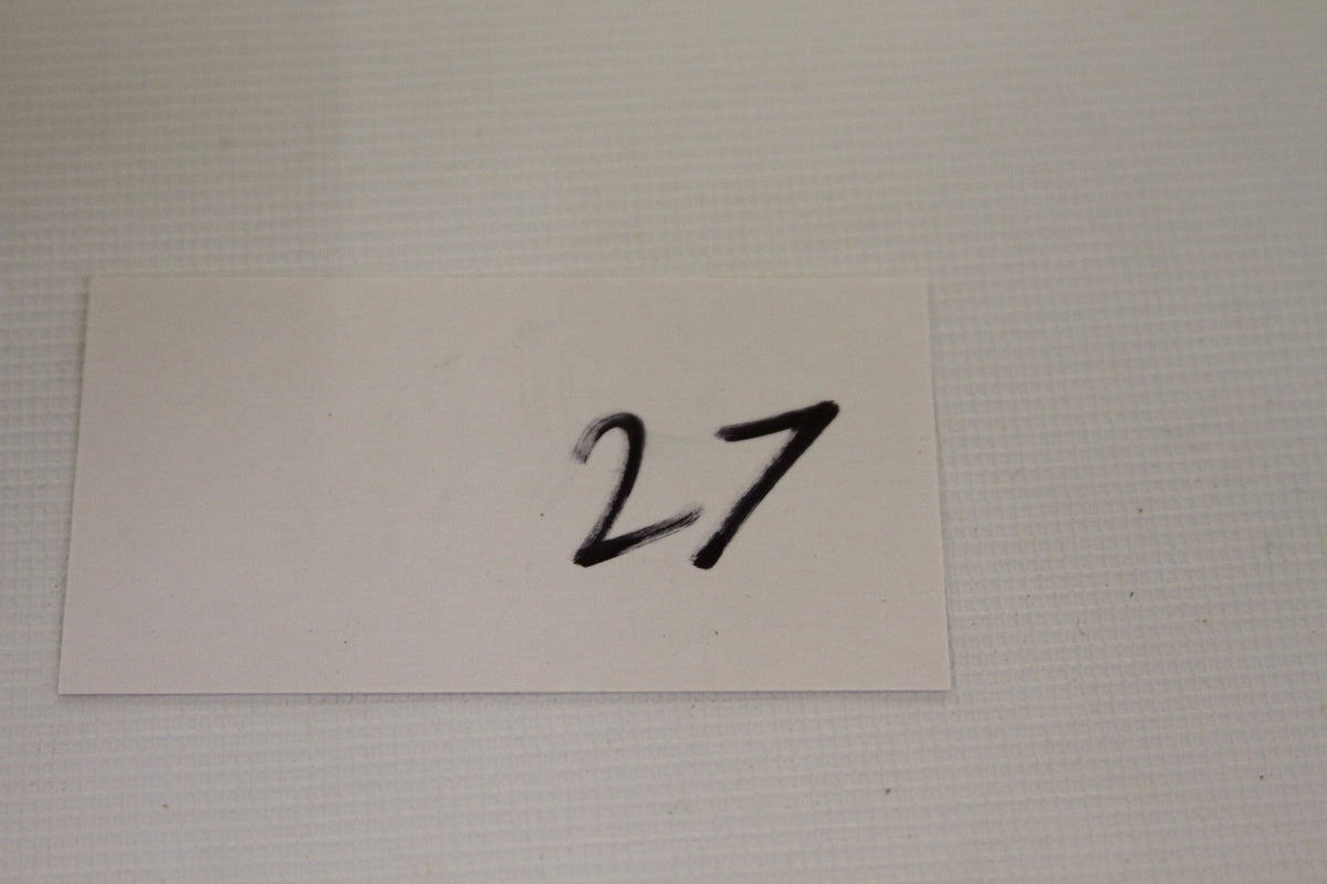 White card with handwritten number 27