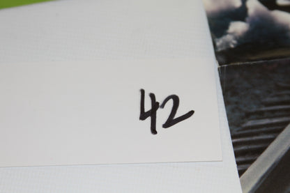 White card with the number 42 written in black marker