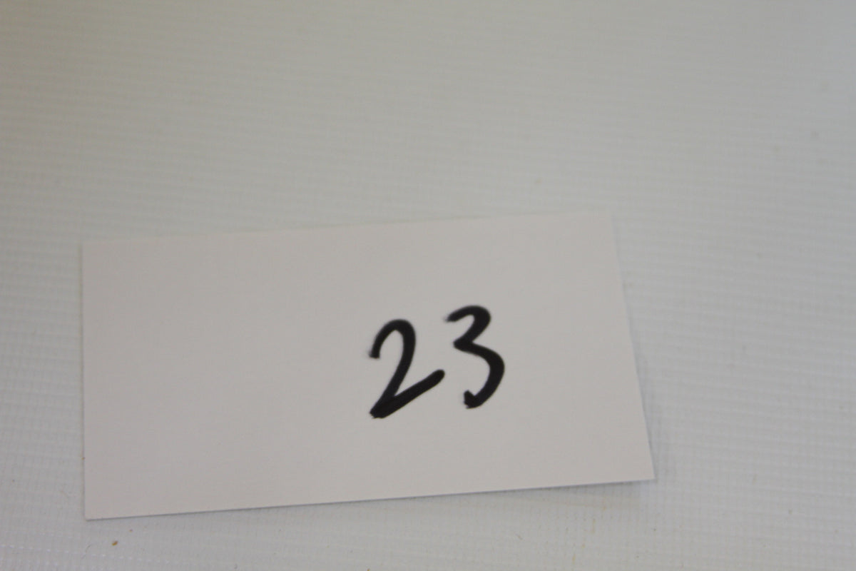 White card with handwritten number 23