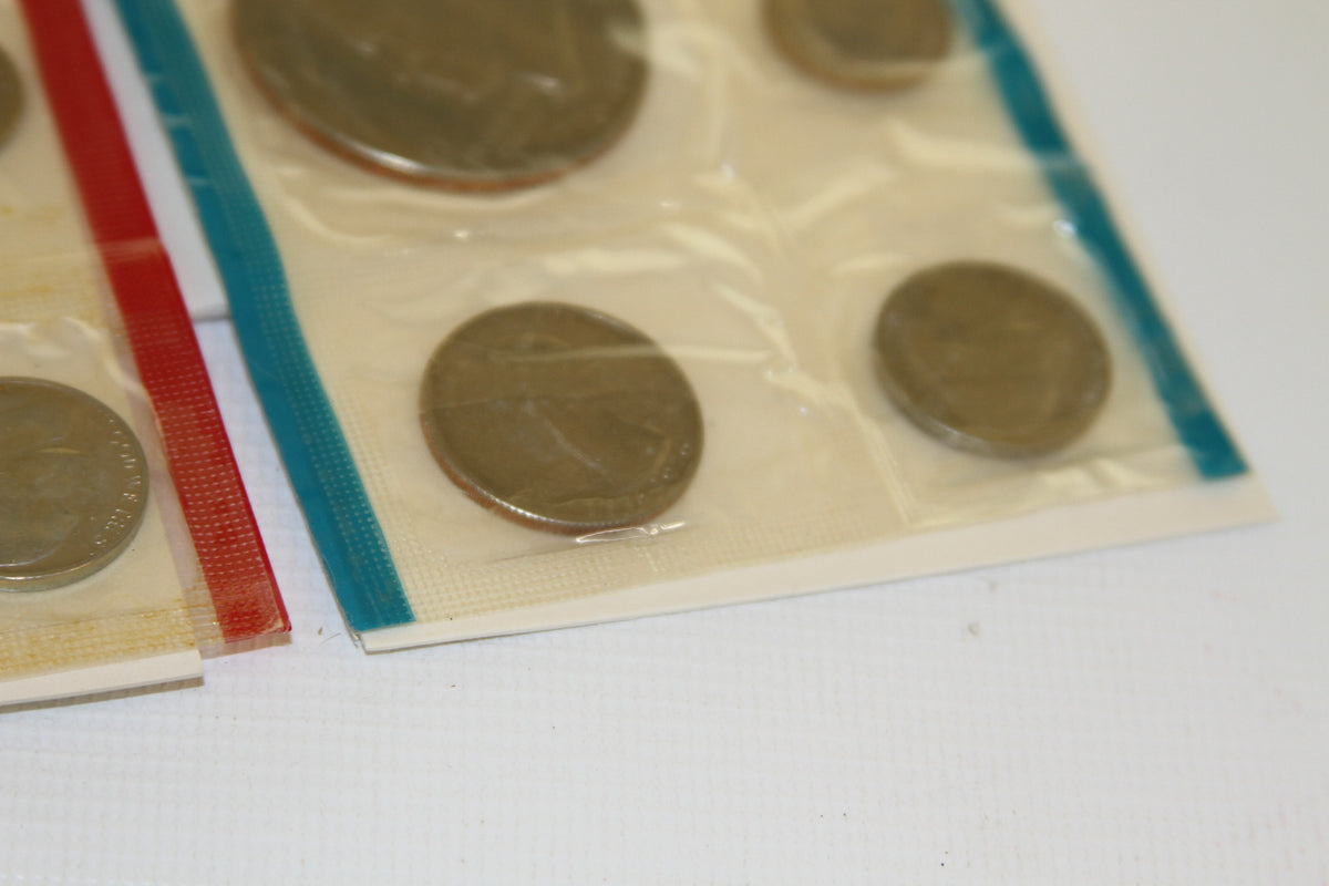 Corner view of U.S. Mint 1975 coins in blue-sealed package