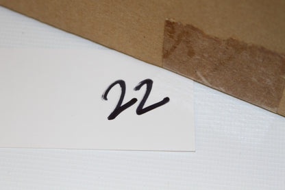 Number 22 handwritten on white card next to sealed Topps box