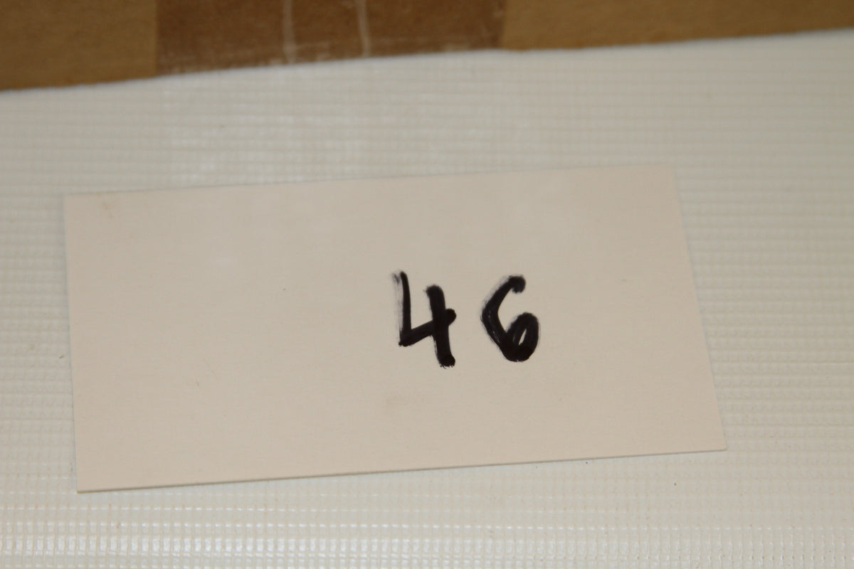 White card with the number 46 beside the box