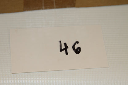 White card with the number 46 beside the box