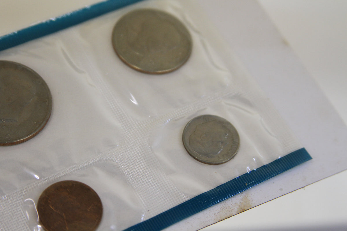 Corner angle of 1979 U.S. Mint coins with blue seal and various denominations