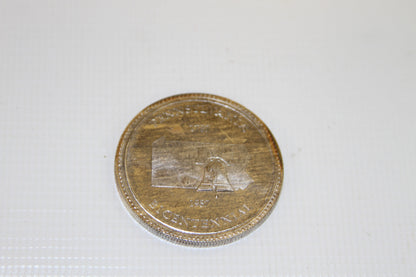 Angled Pennsylvania Bicentennial coin highlighting Liberty Bell and state outline