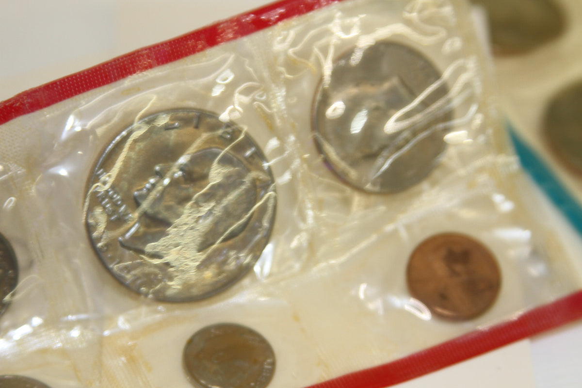 Selective focus on 1975 U.S. Mint coins in red-bordered original plastic