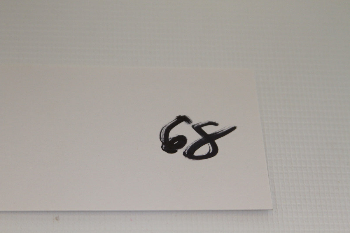 Card with '68' handwritten in black marker