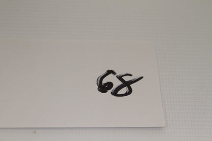Card with '68' handwritten in black marker