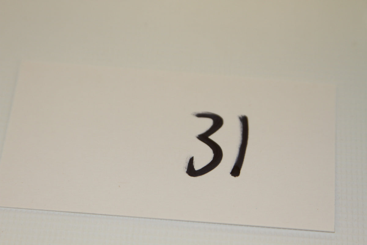 White card labeled 31 in black marker