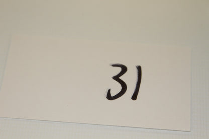 White card labeled 31 in black marker