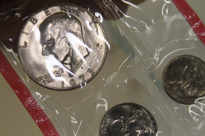 Close-up of 1973 Eisenhower dollar coin in original red-edged packaging