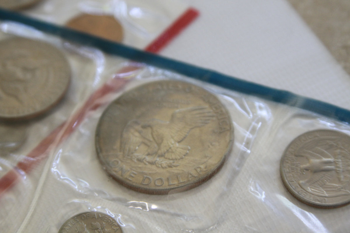 Reverse side of 1978 Eisenhower dollar and additional coins in blue-sealed Mint pack