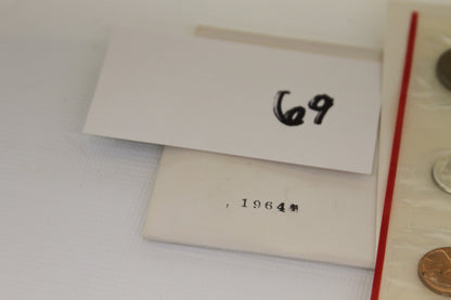 1964 year mark on envelope with item number 69 beside coin sets