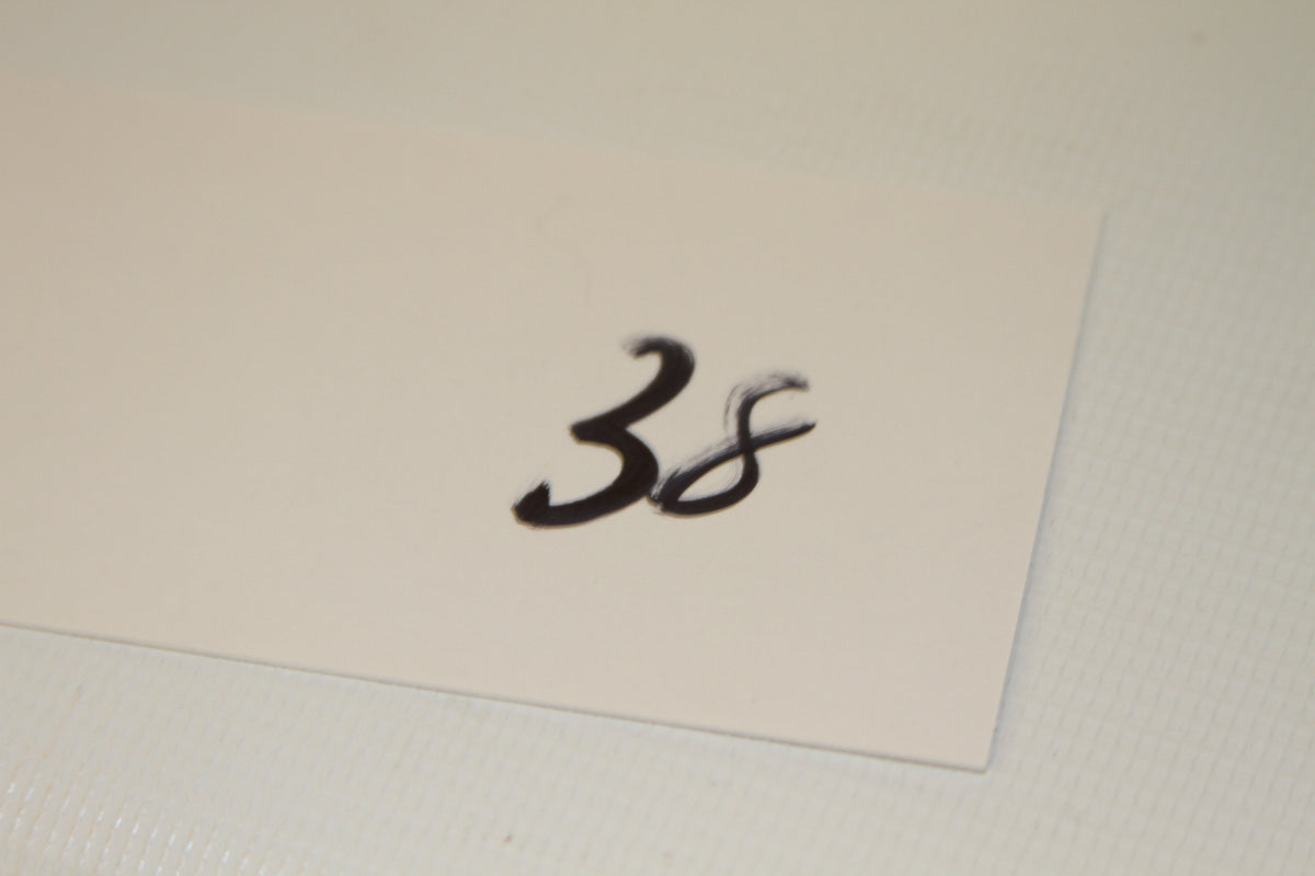 Number 38 written on a small card