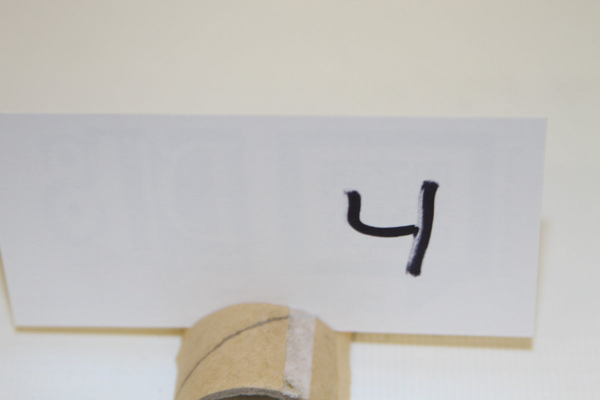 Number 4 on white card placed in front of product