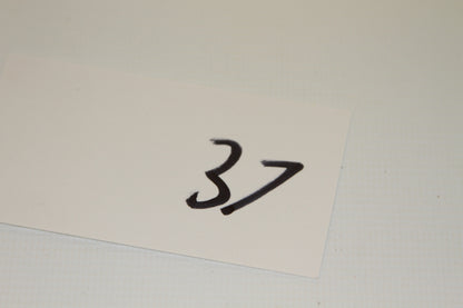 Paper card with handwritten number 37