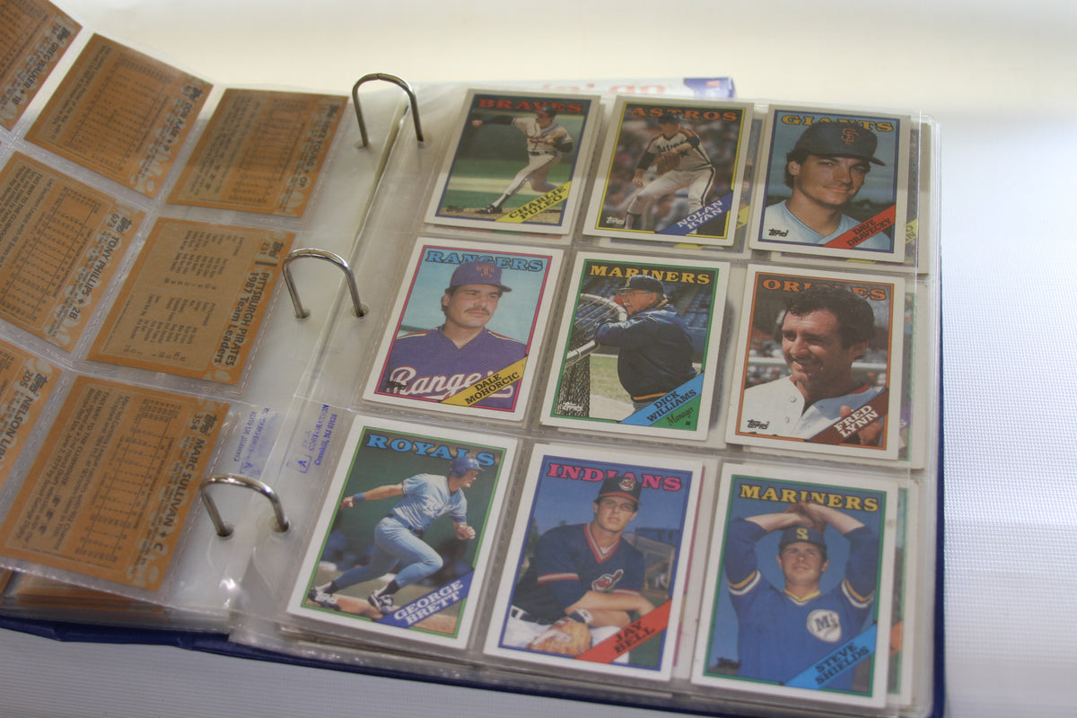 Binder page with Topps cards including Nolan Ryan, George Brett, and more
